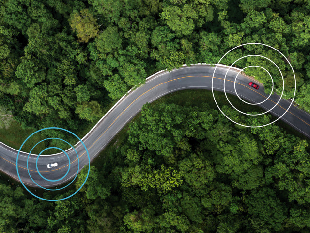 aerial view of two cars sending signals on winding road